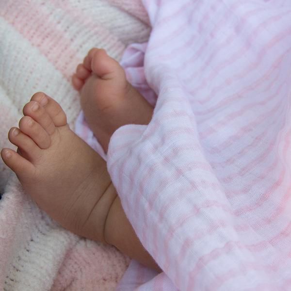 Blush-stripe-muslin-swaddle-wrap-baby-feet-web-grande